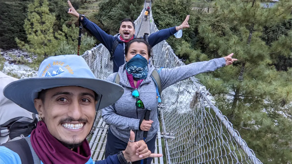 Everest base camp hiking with guide selfie on the route suspension bridge