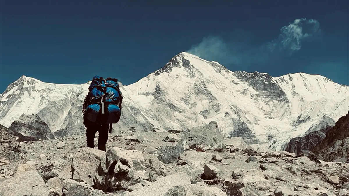 our sherpa porter way uphill to everest base camp EBC