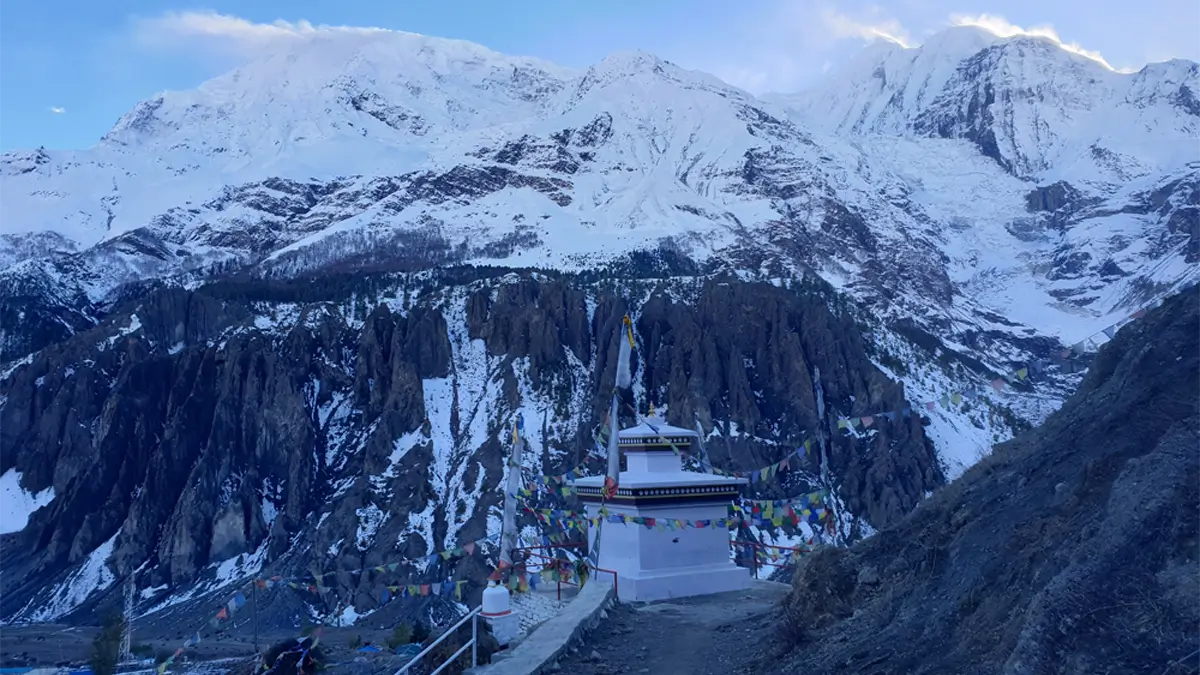 Himalaya mountain view from Manang including Annapurna III, and Gangapurna with small white gumpa in Manang with tibetan prayer flag